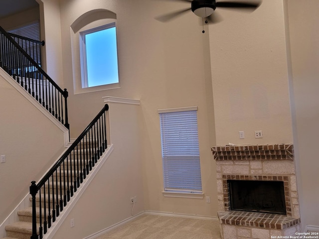 7270 Lunar Eclipse, Converse, TX 78109 - unfurnished living room featuring a ceiling fan, stairway, baseboards, a fireplace with raised hearth, and carpet flooring