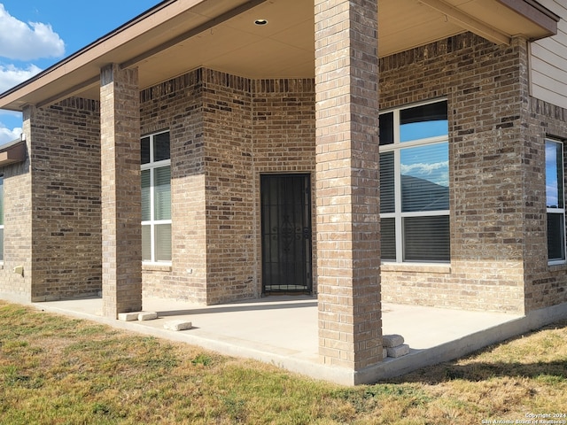 property entrance featuring a patio