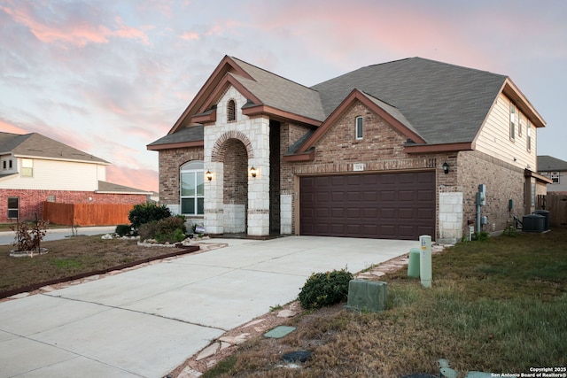 7270 Lunar Eclipse, Converse, TX 78109 - french country inspired facade with concrete driveway, brick siding, a shingled roof, central AC, and stone siding