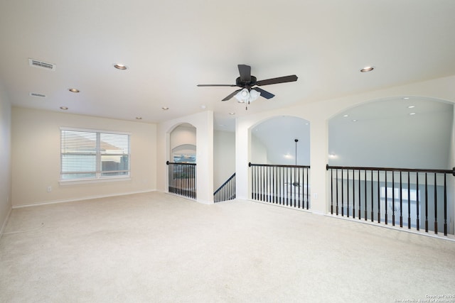 unfurnished living room with ceiling fan and light colored carpet