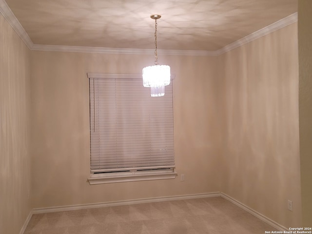 empty room featuring carpet floors, ornamental molding, and a chandelier