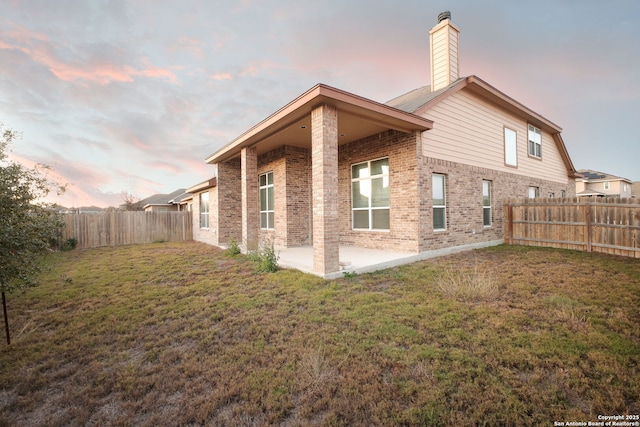 7270 Lunar Eclipse, Converse, TX 78109 - back of house featuring brick siding, a patio area, and a chimney
