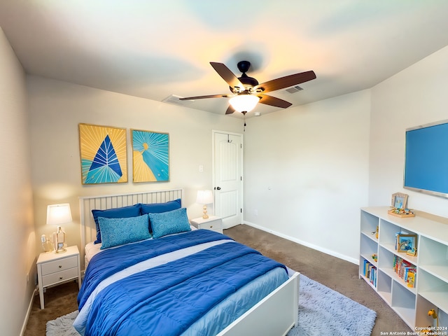 bedroom with dark colored carpet and ceiling fan