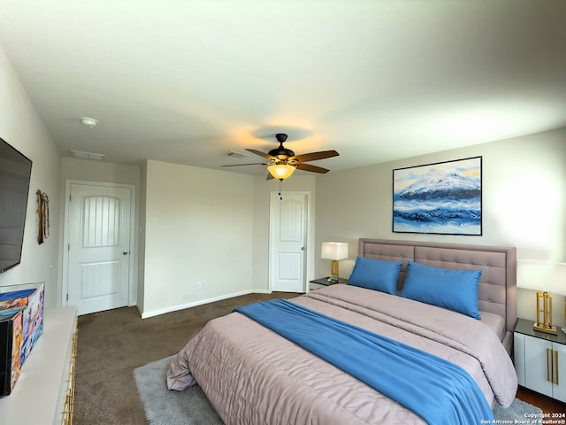 bedroom with ceiling fan and dark carpet