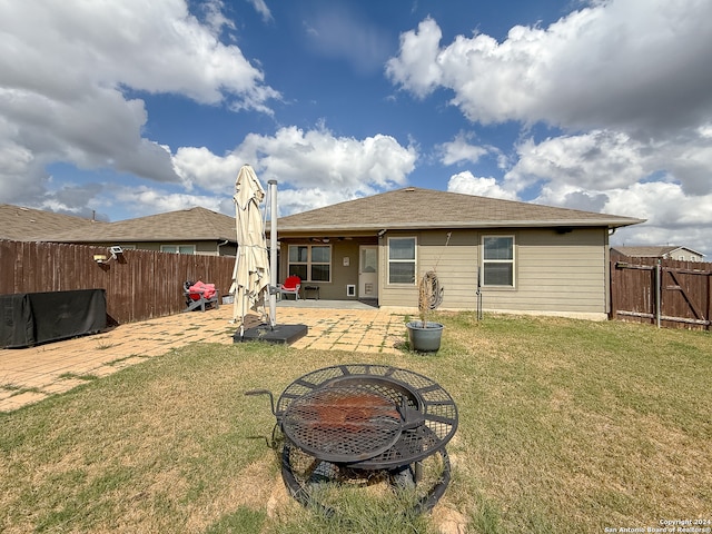 back of house with a yard and a patio area