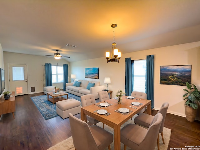 dining room with a wealth of natural light, dark hardwood / wood-style flooring, and ceiling fan with notable chandelier