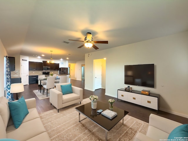 living room with hardwood / wood-style flooring and ceiling fan