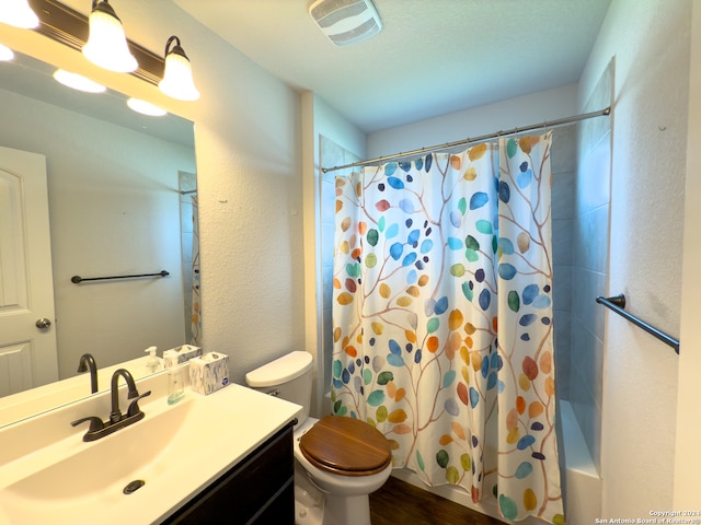 full bathroom with toilet, vanity, hardwood / wood-style floors, and shower / bath combo with shower curtain