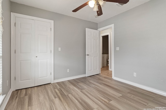 unfurnished bedroom featuring light wood-type flooring, ceiling fan, and a closet