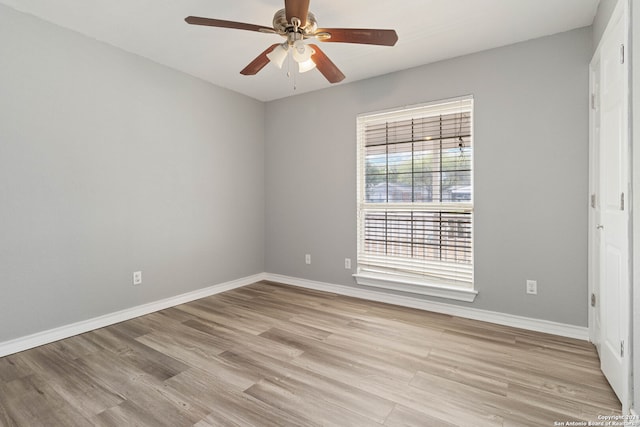 empty room featuring ceiling fan and light hardwood / wood-style flooring