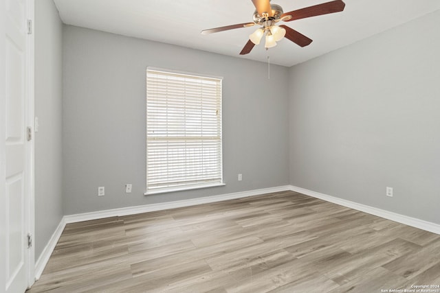 unfurnished room with ceiling fan, a wealth of natural light, and light hardwood / wood-style floors