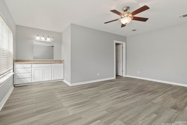 interior space with ceiling fan and light hardwood / wood-style floors