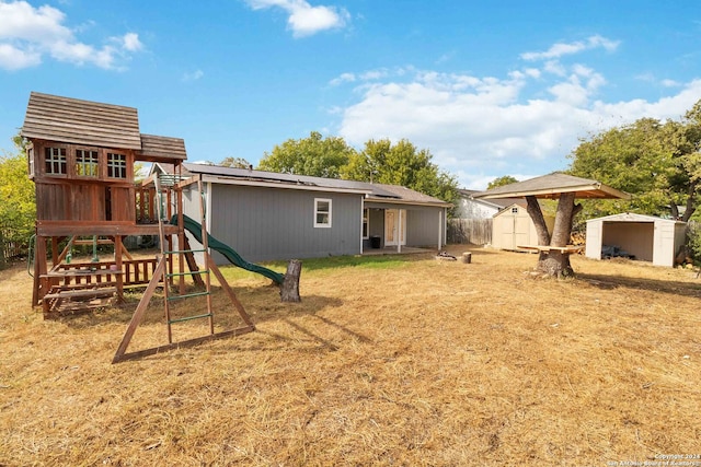 exterior space with a playground and a storage shed