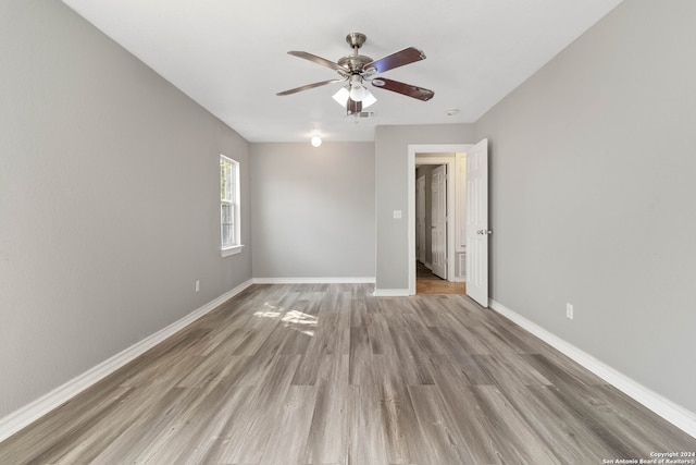 empty room featuring ceiling fan and light hardwood / wood-style flooring