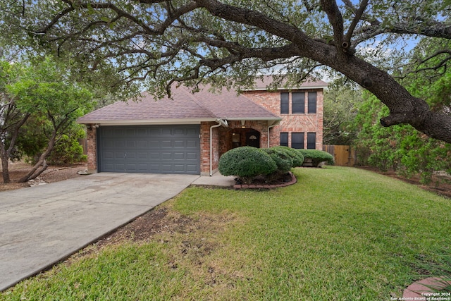 view of front facade with a garage and a front lawn