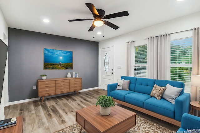 living room with wood-type flooring and ceiling fan