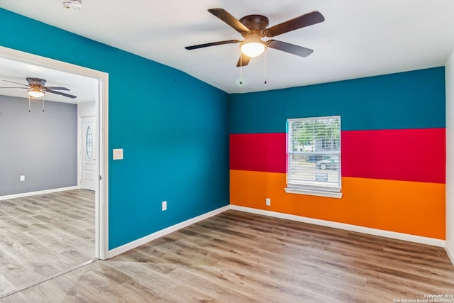 unfurnished room with hardwood / wood-style flooring and ceiling fan