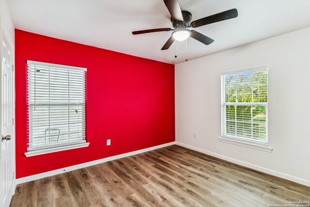 spare room featuring hardwood / wood-style floors and ceiling fan