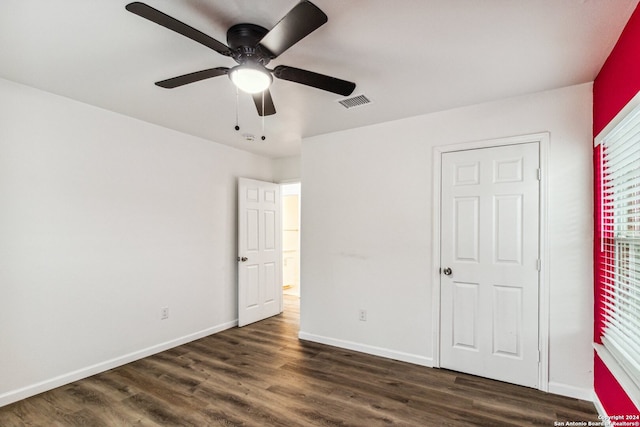 unfurnished bedroom featuring dark hardwood / wood-style flooring and ceiling fan