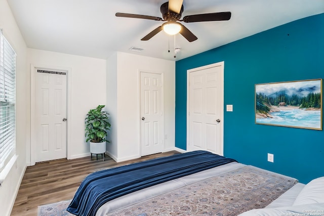 bedroom with wood-type flooring and ceiling fan