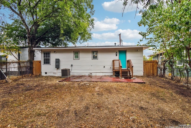 rear view of property featuring a patio area and central AC