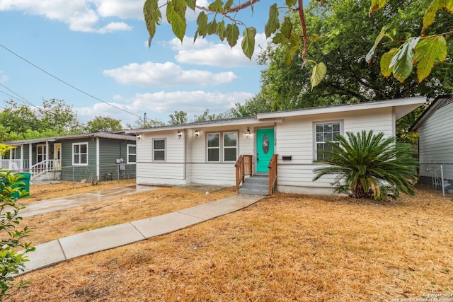 ranch-style home featuring a front yard