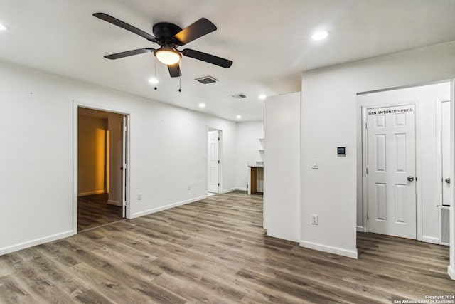 unfurnished room featuring ceiling fan and dark hardwood / wood-style floors