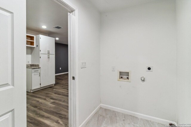1102 Onslow, San Antonio, TX 78202 - washroom featuring hookup for an electric dryer, gas dryer hookup, washer hookup, baseboards, and wood finished floors