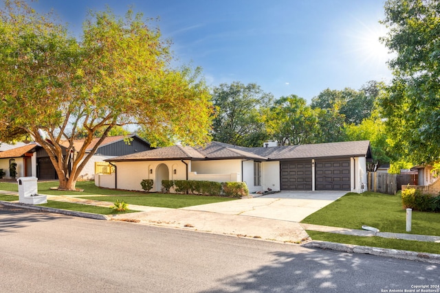 ranch-style house with a front lawn and a garage