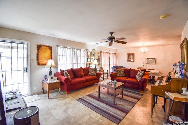 living room featuring ceiling fan with notable chandelier, a healthy amount of sunlight, and a wall mounted AC