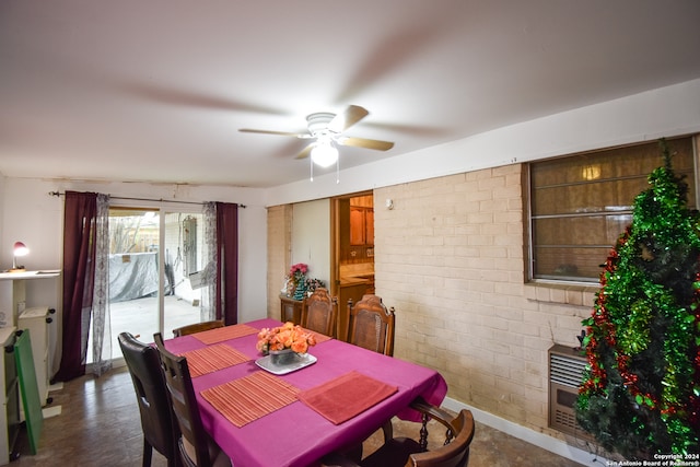 dining area featuring brick wall, ceiling fan, and dark hardwood / wood-style floors