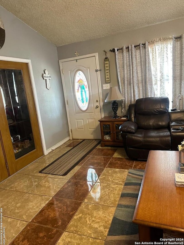 tiled living room featuring a textured ceiling and vaulted ceiling