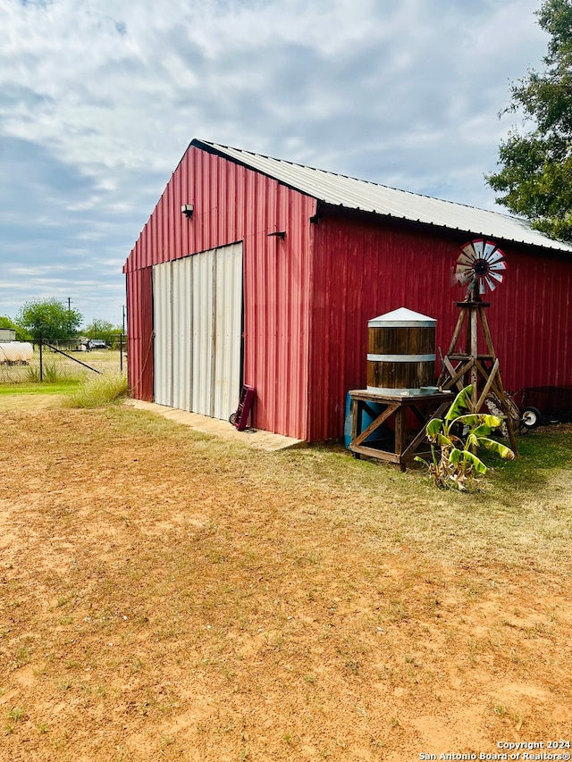 view of outbuilding featuring a lawn