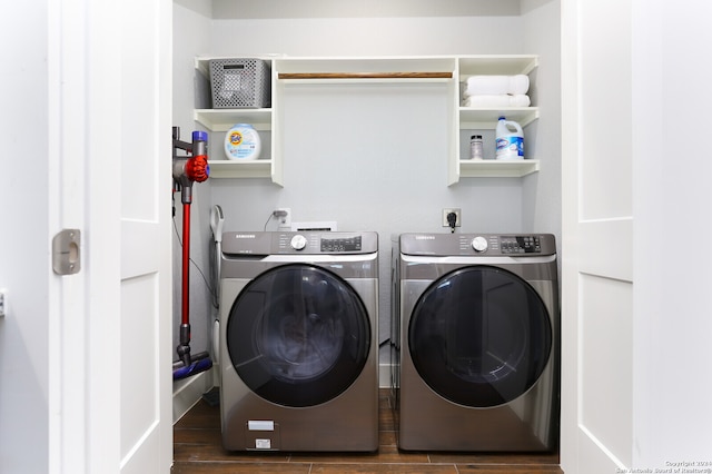 clothes washing area featuring washer and clothes dryer and dark hardwood / wood-style flooring