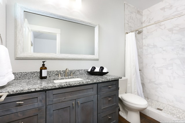 bathroom with toilet, vanity, and walk in shower