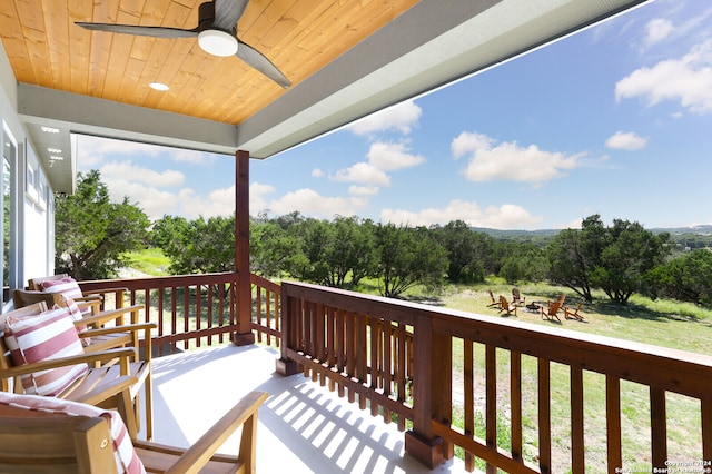 wooden terrace featuring ceiling fan