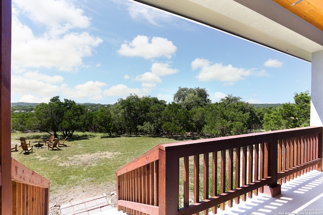 wooden deck with a lawn