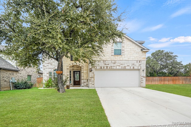 view of front facade with a garage and a front yard