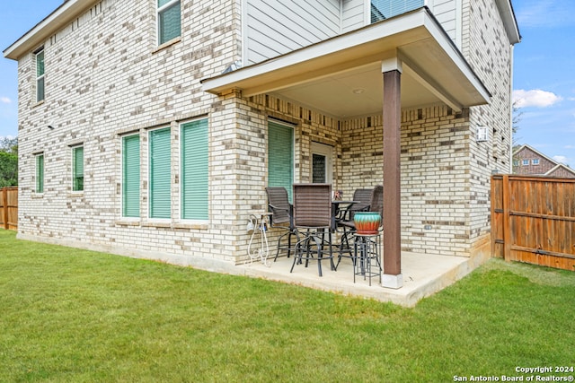 back of house with a yard and a patio area