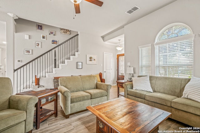 living room with light hardwood / wood-style floors and ceiling fan