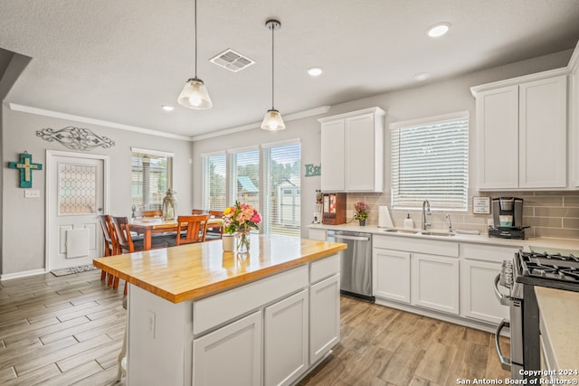 kitchen featuring white cabinetry, light hardwood / wood-style floors, stainless steel appliances, and sink