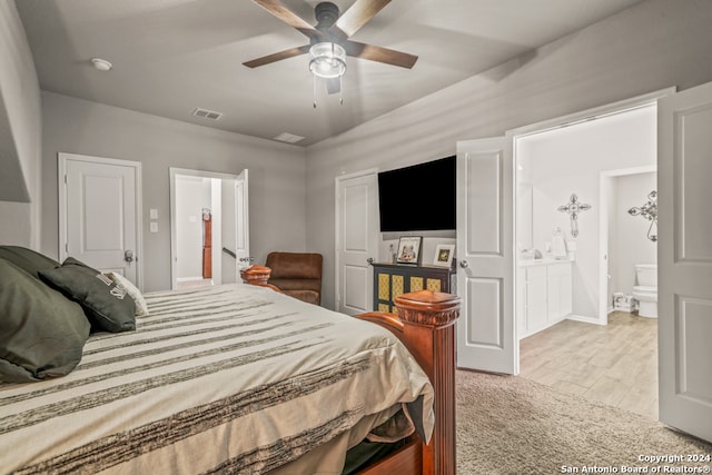 bedroom with ensuite bathroom, ceiling fan, and light hardwood / wood-style floors