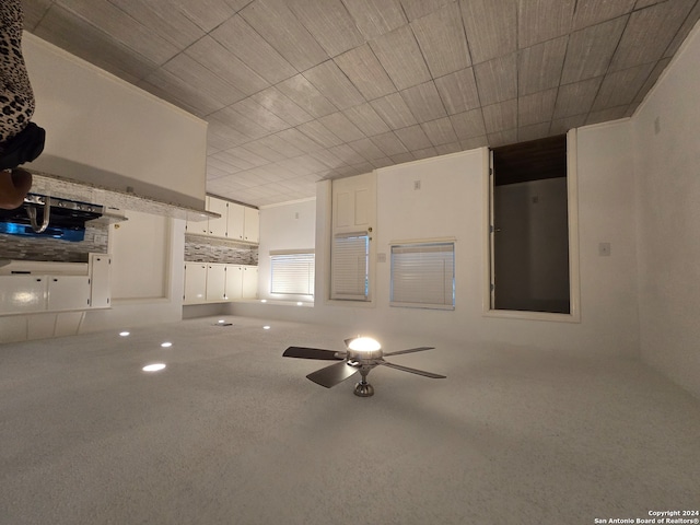 interior space with carpet flooring and ceiling fan