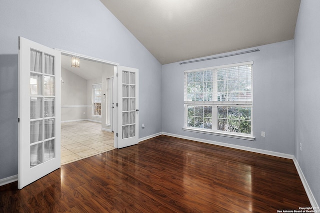 empty room featuring lofted ceiling, french doors, and light wood-type flooring