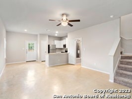 unfurnished living room with ceiling fan