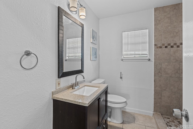 bathroom featuring tile patterned flooring, vanity, and toilet