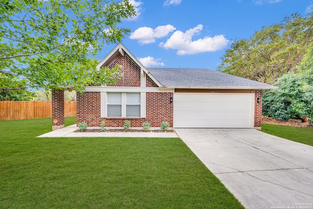 view of front of home with a front lawn and a garage