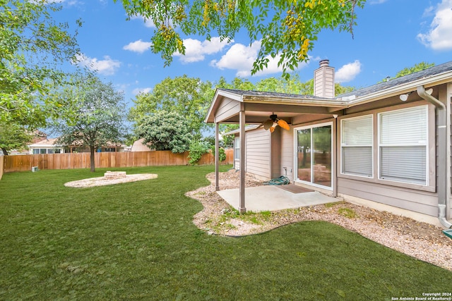 view of yard with a patio area, ceiling fan, and a fire pit