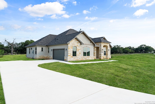 french provincial home with a garage and a front lawn