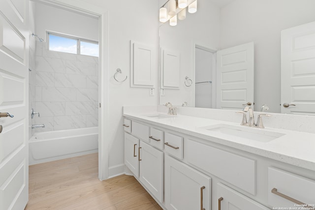 bathroom featuring tiled shower / bath combo, vanity, and hardwood / wood-style flooring